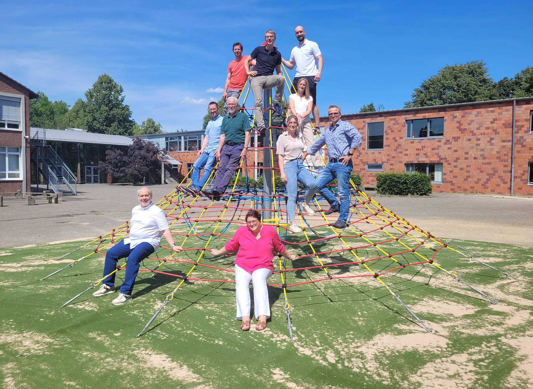 Vertreter der Schulen, des Stadtrats und aus der Verwaltung eröffneten gemeinsam die neuen Spielgeräte, hier die Seilpyramide auf dem Schulhof des Gymnasiums.