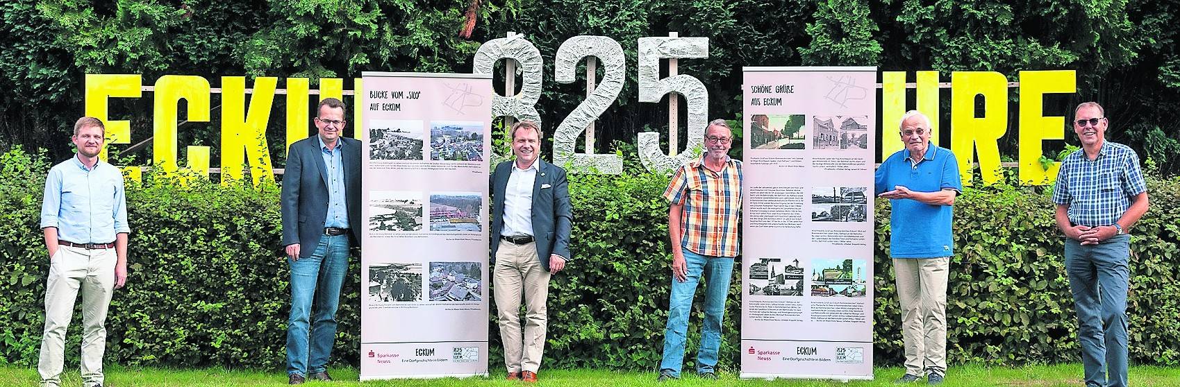  Martin Lambertz, Wolfgang Huettche (Sparkasse), Bürgermeister Martin Mertens (Gemeinde Rommerskirchen), Arnd Picker, Wolfgang Grubert, Hans Bernd Lender (BSV Eckum) präsentieren hier – ebenfalls Corona konform – zwei der Ausstellungs-Fahnen.  